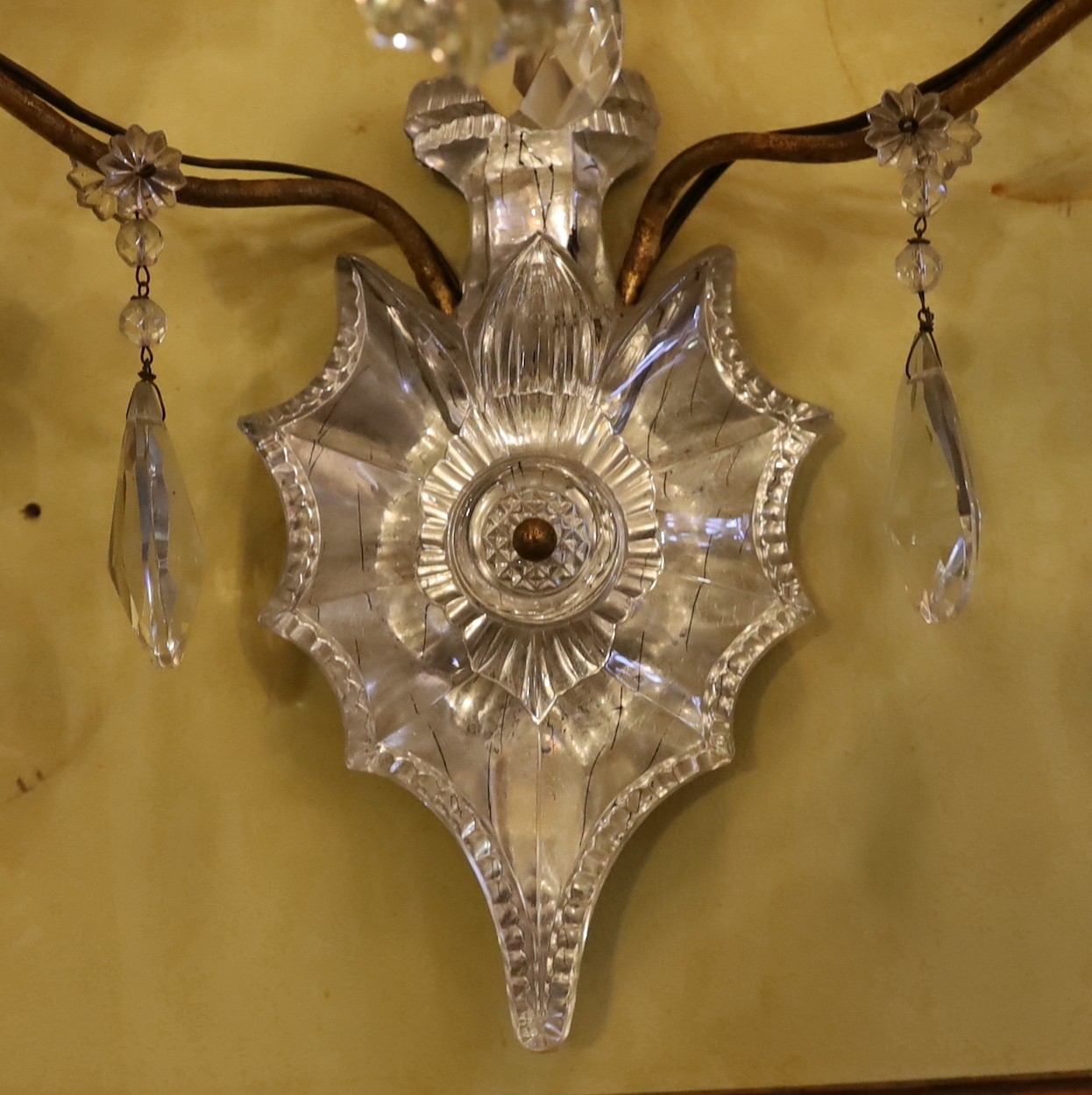 An early 20th century French gilt metal and Baccarat crystal triple branch wall light, height 68cm. width 36cm